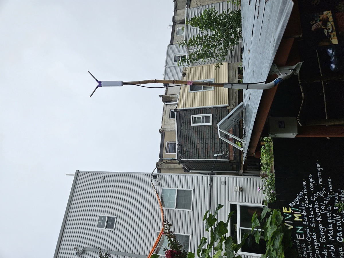 The full solar mesh node at Colobo Gardens: the access point atop the bamboo mast, with the solar panel mounted on the roof below